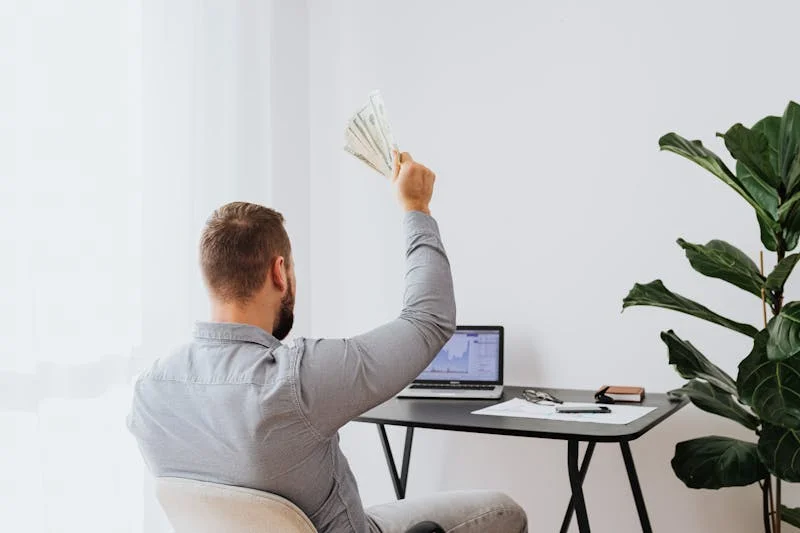 person celebrating after learning about investing online